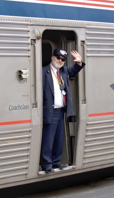 Amtrak train conductor waving from Empire Builder train in Portage Wisconsin. 