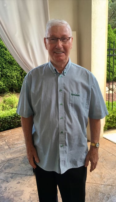 a man in a blue shirt and black pants