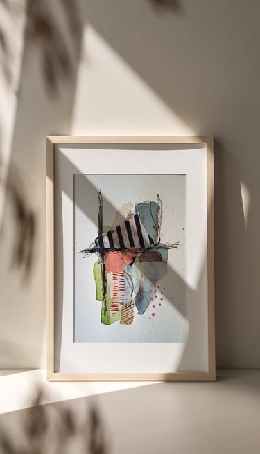 Framed abstract mixed media artwork by Sweet Ruby Moon with layered textures and bold color, lit by soft natural light