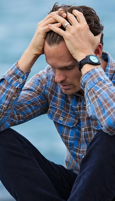 a man looking anxious with head in hands