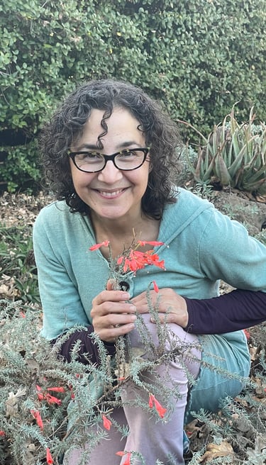 Katrina Matos, skin care formulator and Earth Energy Connection guide, with blooming California fuschia