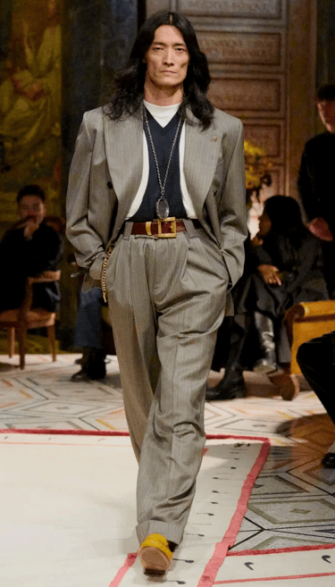 Versace Spring Summer 2026 – Grey pinstripe suit with gold accessories.