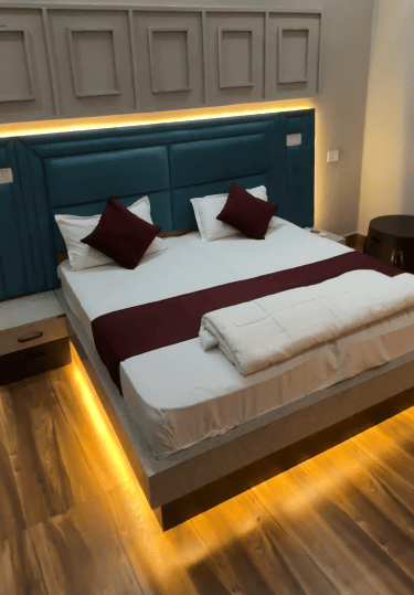 a bed with a bed and a chair, Shikohabad me accha hotel