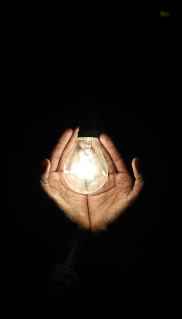Hand cupping a LED bulb