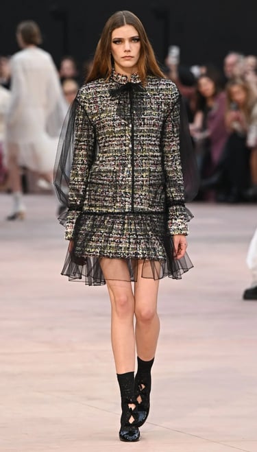 Multicolor tweed dress with tulle sleeves and hem at Chanel FW25/26.