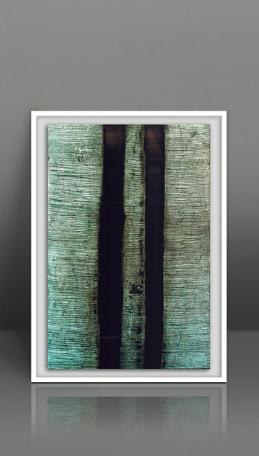 Framed abstract vertical texture painting in green and black on a grey wall.
