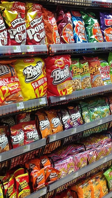 Various bags of chips on a gondola in a store