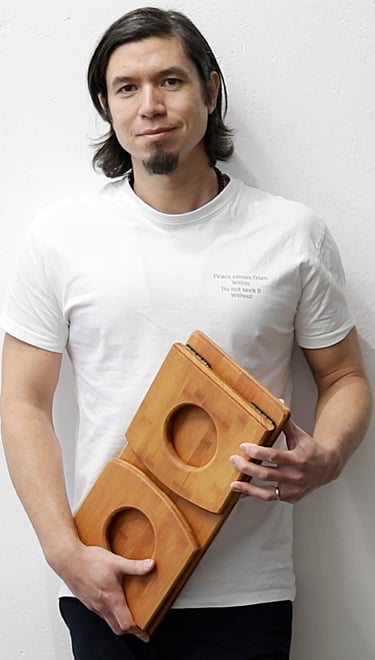 Teacher and founder Jeff holding a self-made meditation bench