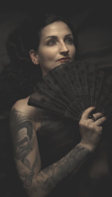 portrait of a woman holding a black fan