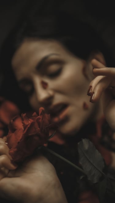 a woman with tattoos on her arms and rose petals, her mouth is open