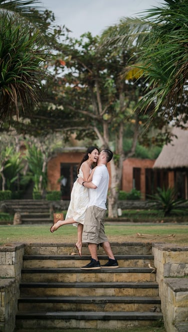Intimate couple walking down garden steps at Waka Gangga resort in Tabanan West Bali