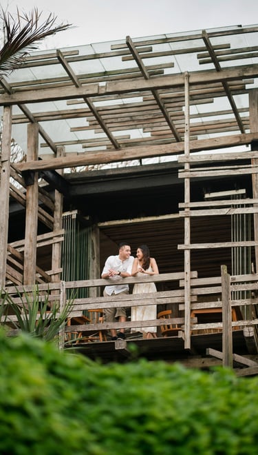 Couple sharing quiet moment on wooden balcony at Waka Gangga resort in Tabanan West Bali