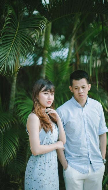 Intimate couple portrait in tropical garden at Sofitel Bali Nusa Dua Beach Resort.