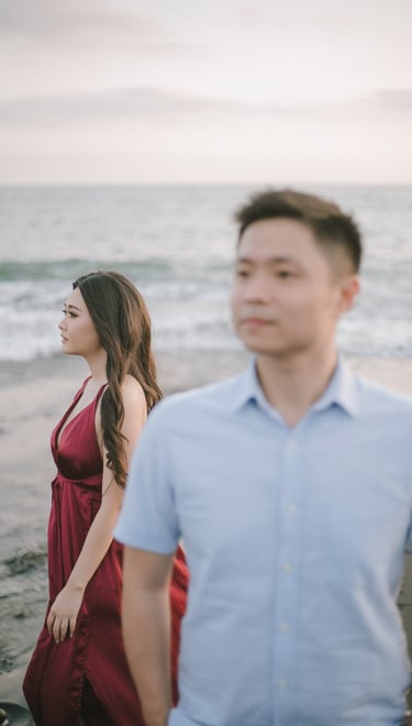 Intimate couple walking along the beach at sunset in Pantai Nyanyi Bali.