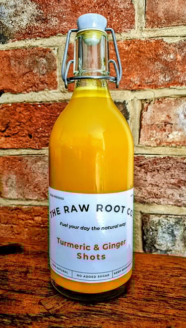 Turmeric and Ginger swing top shot bottle from The Raw Root Co. The Turmeric and Ginger juice is a vibrant orange colour.