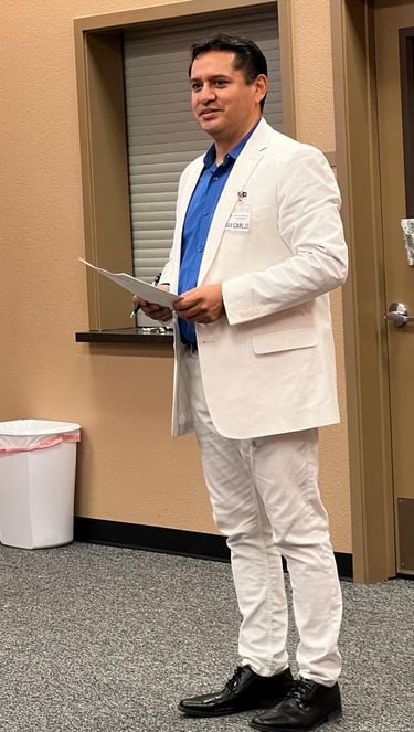 a man in a white suit and blue shirt