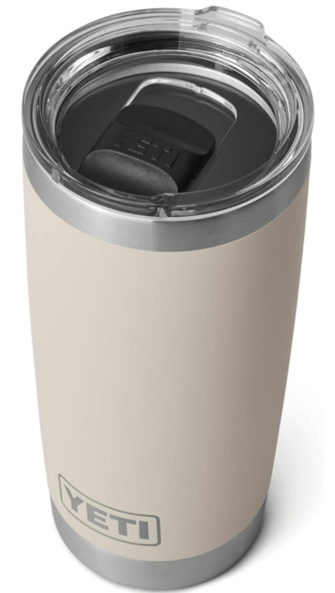 Neutral beige YETI tumbler with clear lid, perfect for cozy drinks.