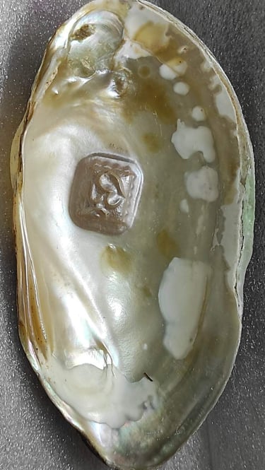 "Side view of 11mm white designer cultured pearl with detailed Om engraving–Globally tradable"