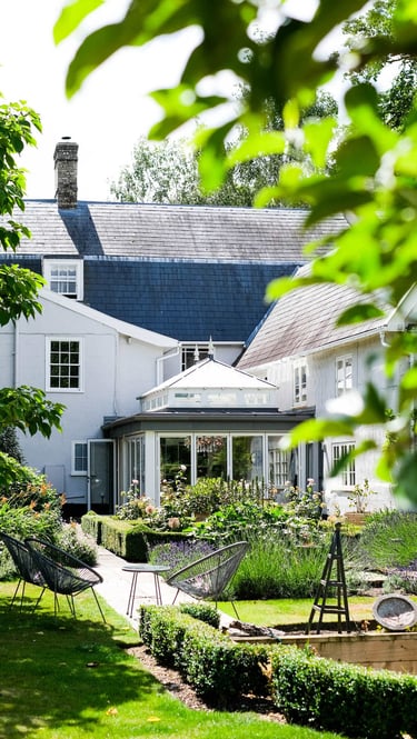 Exterior view of a classic orangery extension designed to connect the home and garden in Suffolk.