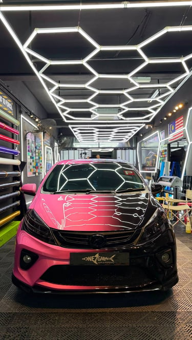 Perodua Myvi wrapped in pink and black gradient vinyl finish