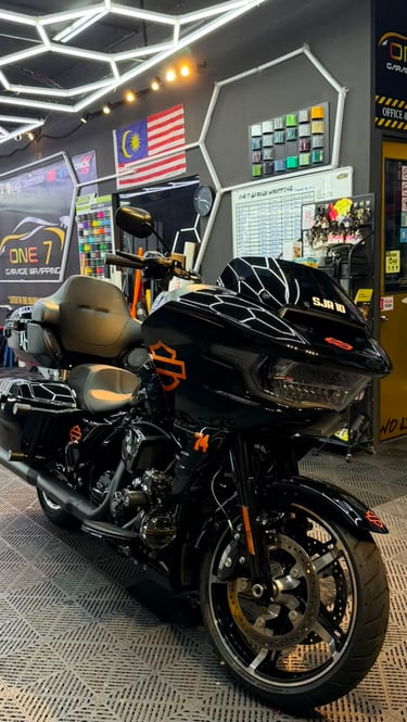 Harley-Davidson touring motorcycle with black and orange custom wrap