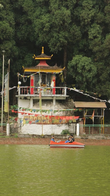 a boat on Lampokhari with a temple in the background