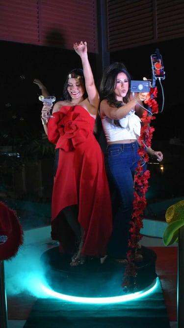 two women standing on a stage with a microphone