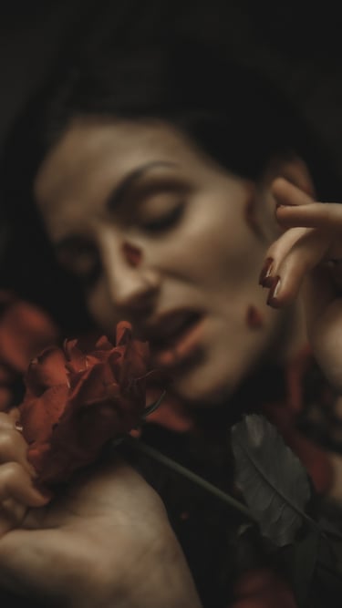 a woman with tattoos on her arms and rose petals, her mouth is open