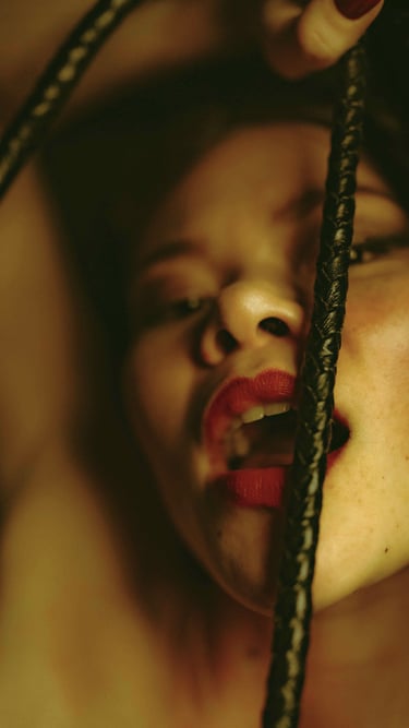 a woman taken in picture playing with a black whip