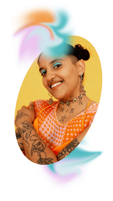 A picture of an indian woman with jewelry smiling at the camera with a yellow background