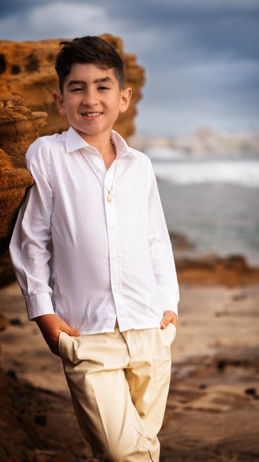 a boy in a white shirt and tan pants