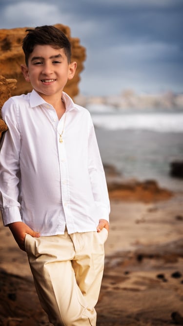 a boy in a white shirt and tan pants