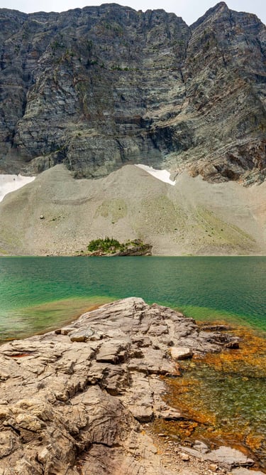 Crypt Lake’s turquoise water beneath steep mountain cliffs in Waterton Lakes National Park.