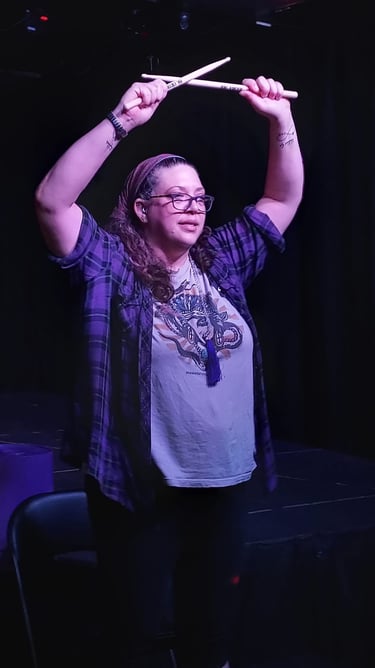 Hands up drumsticks crossed on stage