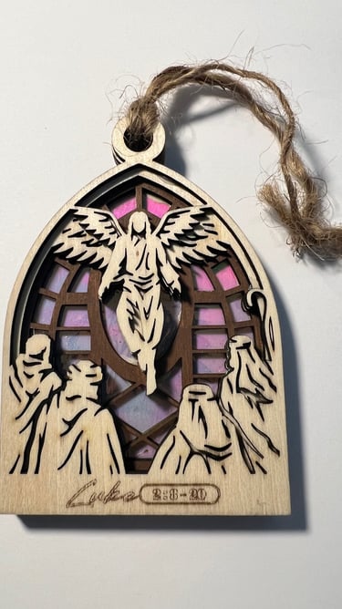 Wooden langing ornament with angel and figures over a stained glass style background