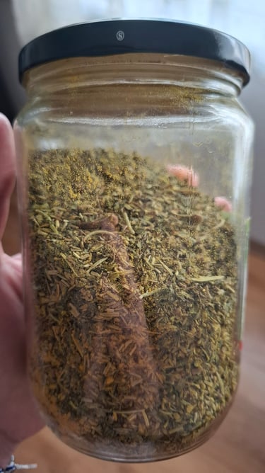 a person holding a jar of herbs in a jar