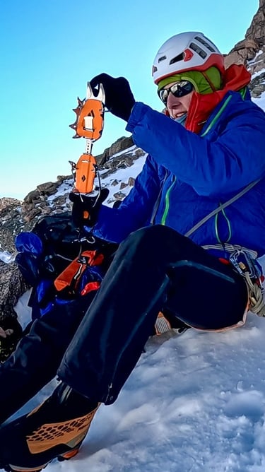 Lisa Foster putting on her Black Diamond Sabretooth Pro Crampons on her way up Longs Peak