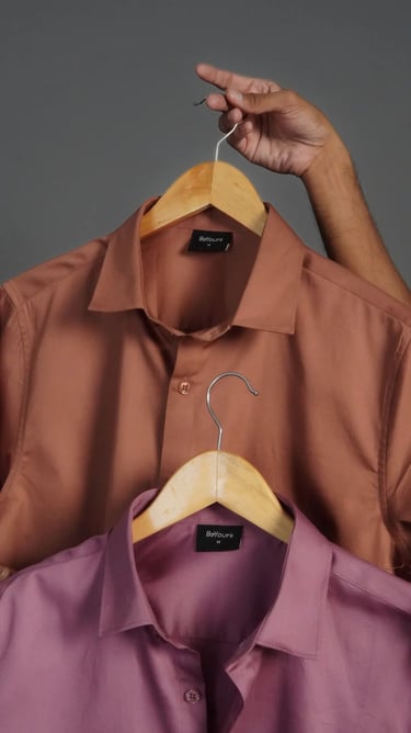 a man holding a hanger with a hanger of a shirt on it