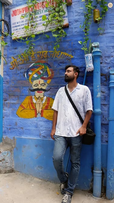 Colorful mural of a Rajasthani man painted on a blue wall in Jodhpur, reflecting local culture and street art.