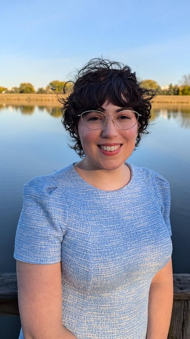A picture of Rae O'Connor standing in front of a pond