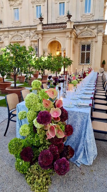 Elegant outdoor wedding dinner table with floral centrepiece, Rome.