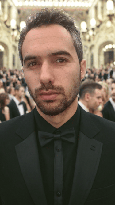 a man in a tuxedo suit and bow tie his name is Karim Lazaar