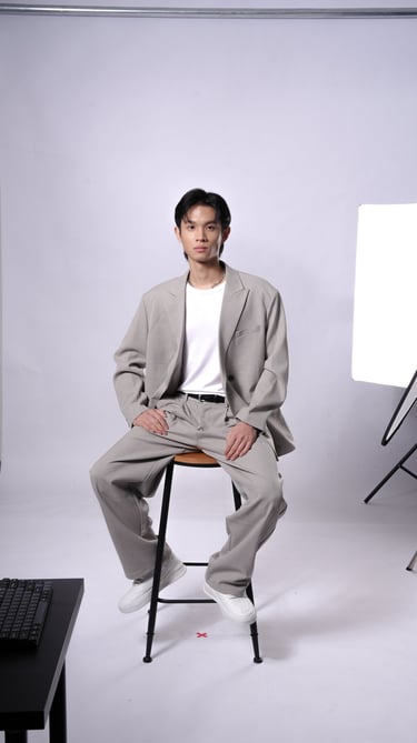 Derron posing in formal outfit during indoor photoshoot