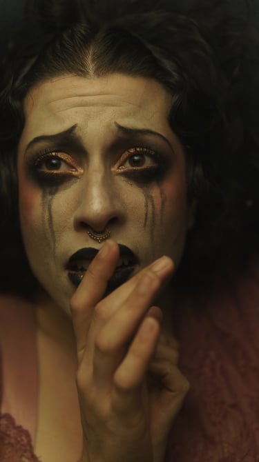 a woman with black makeup and makeup dropping on her face