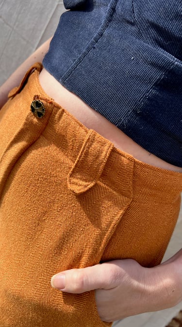 Waist detail of a navy corduroy bustier and honey brown flannel pants