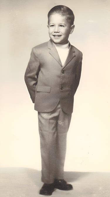 Brett Beoubay modeling children's clothing, specifically slacks and a blazer