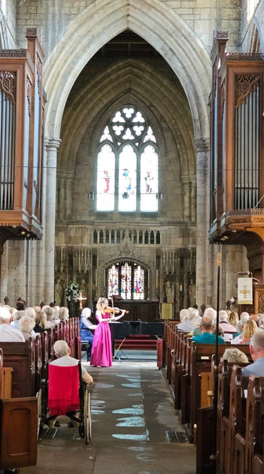 Charlotte Rowan performing in pink dress, live at Howden Minster, Yorkshire