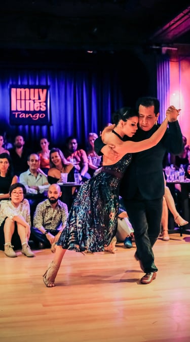 a couple dancing tango in a dance floor 