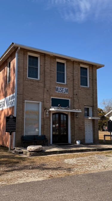 A brick building , museum of hardin county located in Kountze