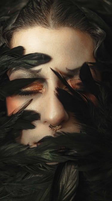 a cabaret performer with a black and white face and black feathers